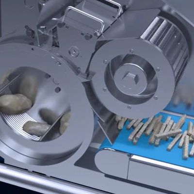 High-tech machine processing and sorting small cylindrical objects on a conveyor belt.