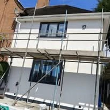 House exterior under renovation with scaffolding around it.