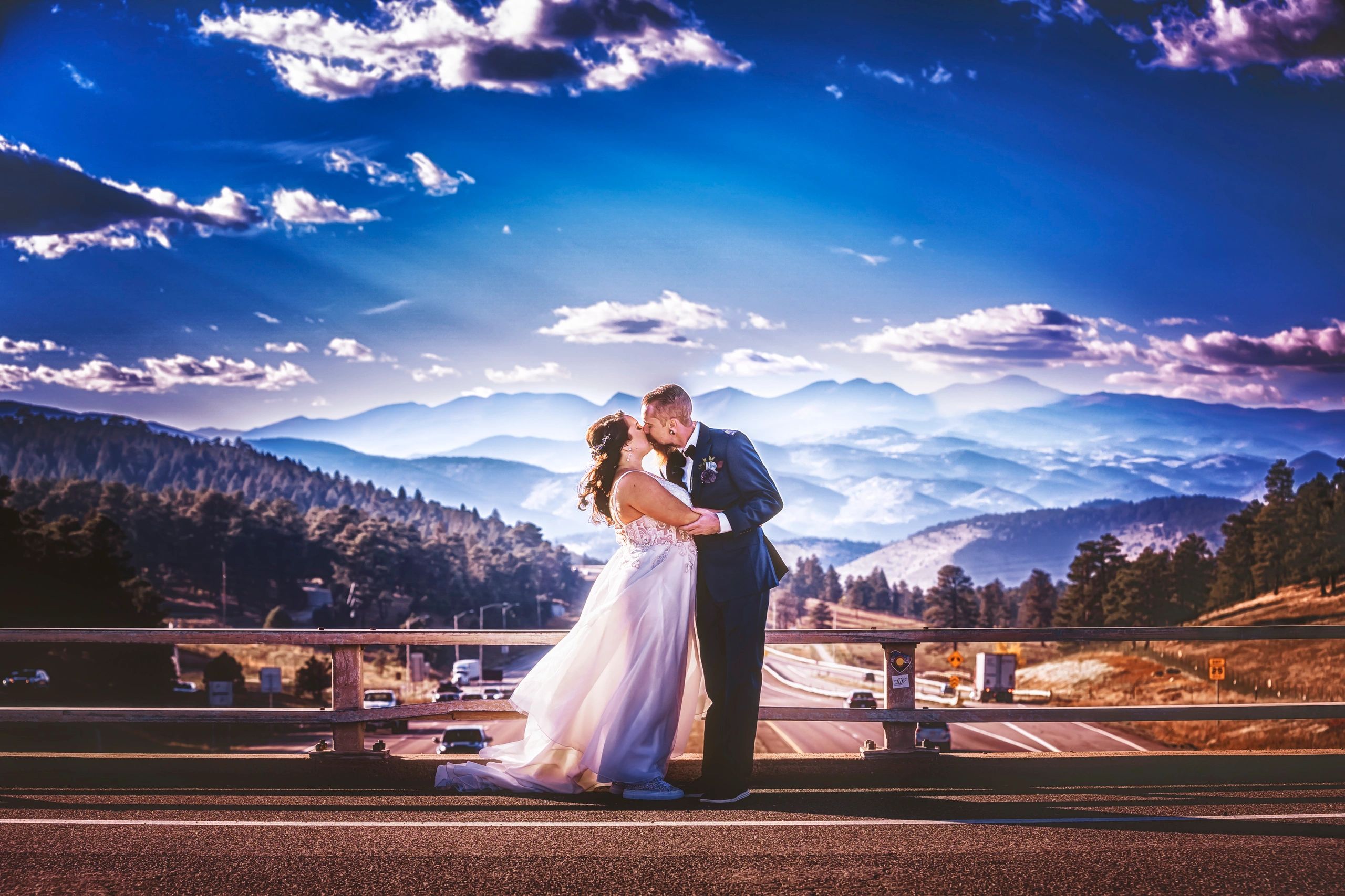 Happy newlyweds kissing on the Gennessee Bridge in Colorado
