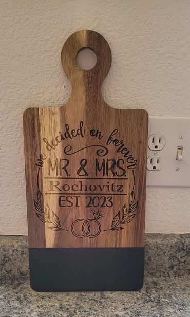 Wooden cutting board engraved with wedding details for Mr. & Mrs. Rochovitz, established 2023.