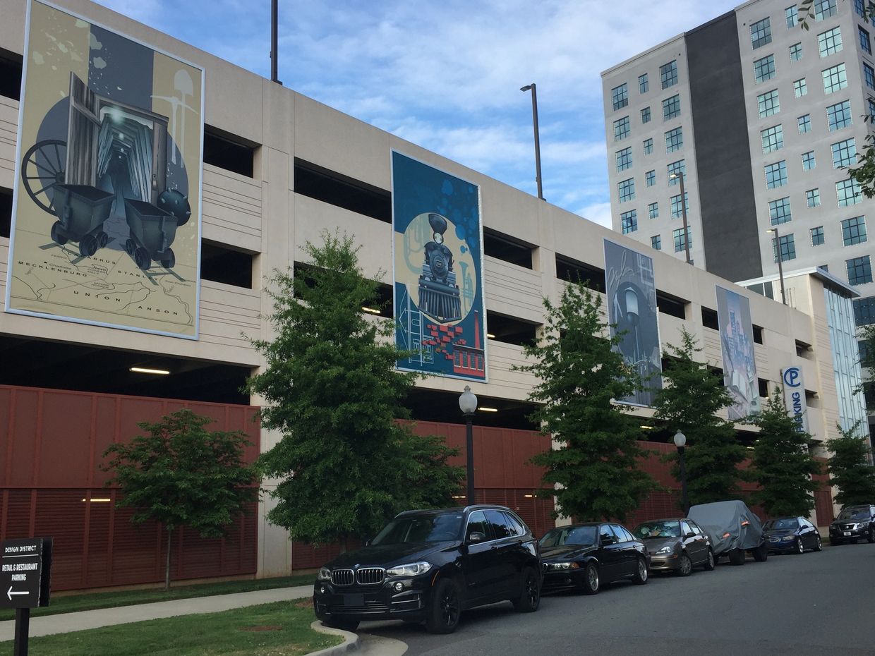 Large photographic panels installed on a parking deck that tell the history of South End.