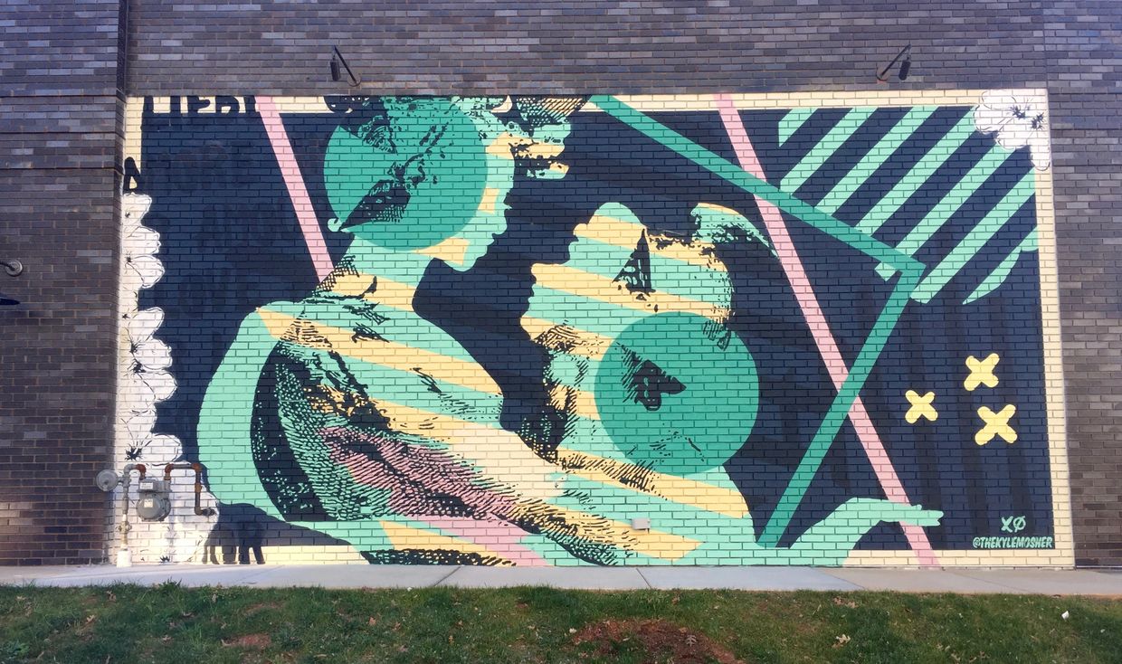 2 green and yellow striped figures embrace with love written in different languages in background.