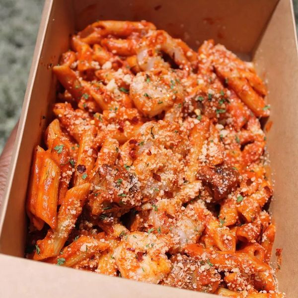 a marinara pasta, penne with jerk pork juicy meat sauteed shrimp, In a tomato sauce parmesan cheese