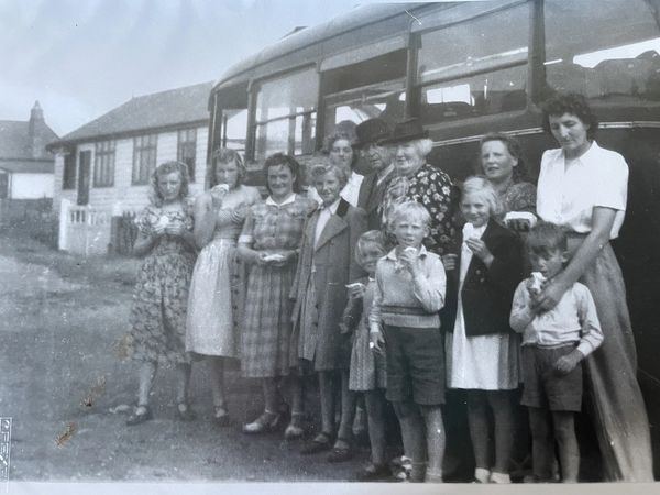 Brisley village residents standing by a coach