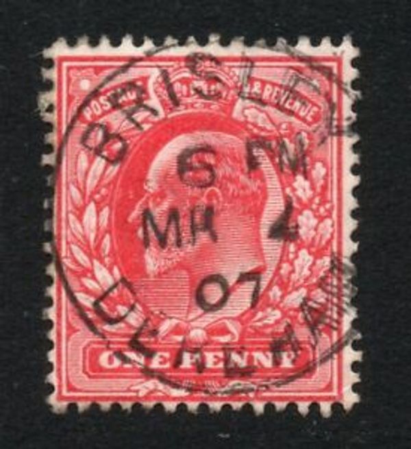A red postage stamp with a Brisley postmark