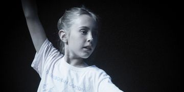 Young girl practicing dance moves.