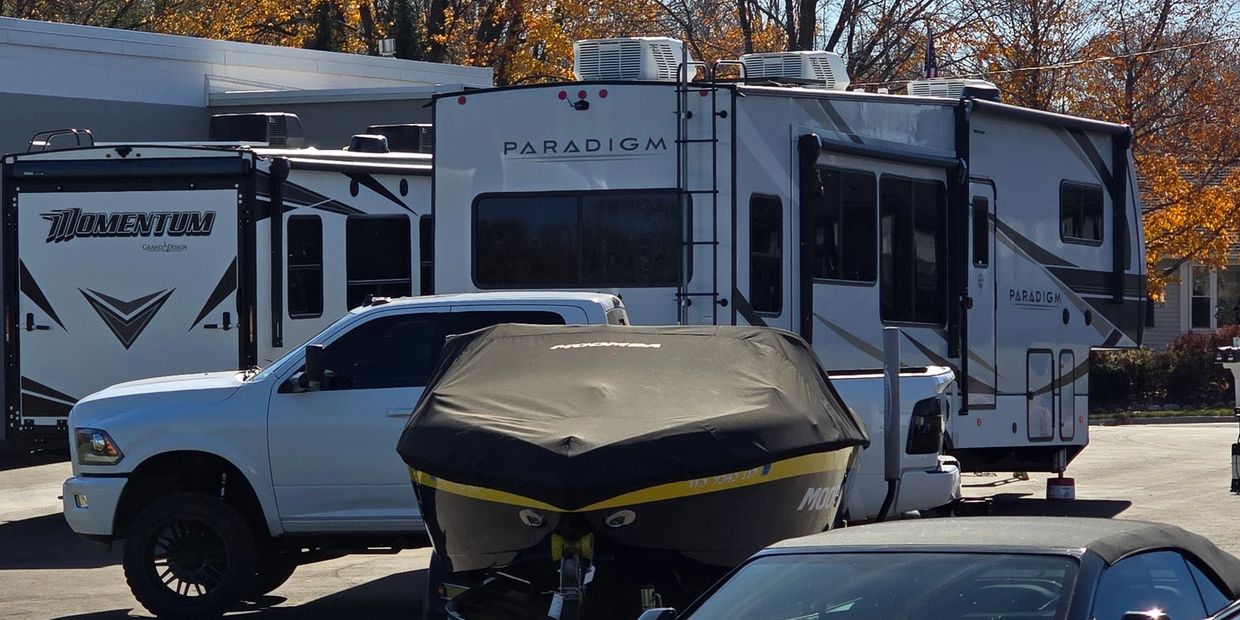 Sports car, wake boat, pick up truck, fifth wheel camper, bumper pull camper at the Motorhead shop.