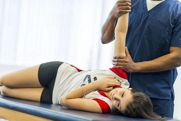 Therapist stretching an athletic woman for kinetic cupping