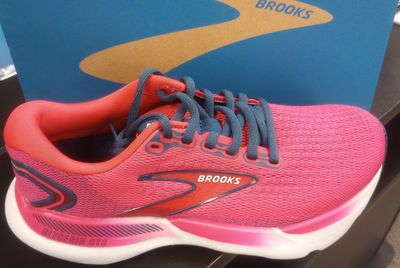 A picture of pink color brooks brand shoe