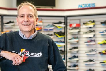 Man smiling in a shoe store.