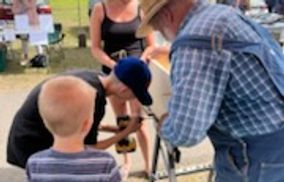 Mr. Ed helping a young man put together his planter