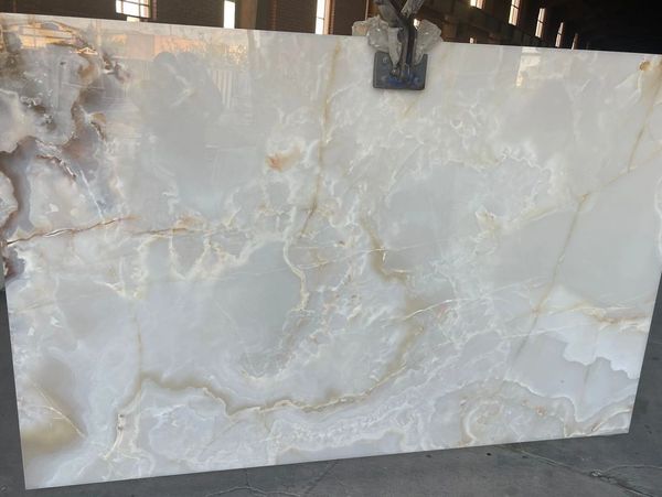 Smooth white marble surface with subtle beige veins.