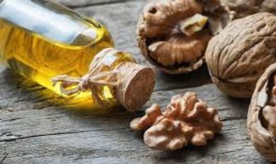 Bottled Organic Walnut oil and raw walnuts on a table