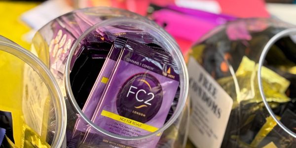 Close-up of condoms in a transparent jar.
