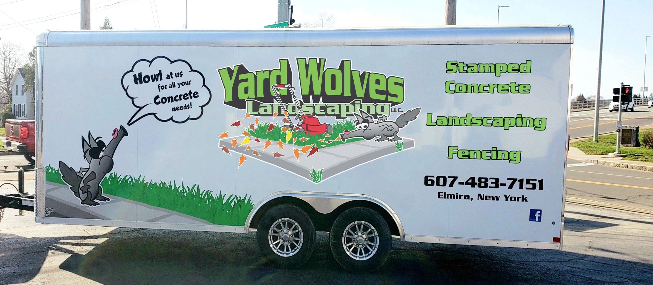 Yard Wolves Landscaping trailer showing services: stamped concrete, landscaping, fencing. 