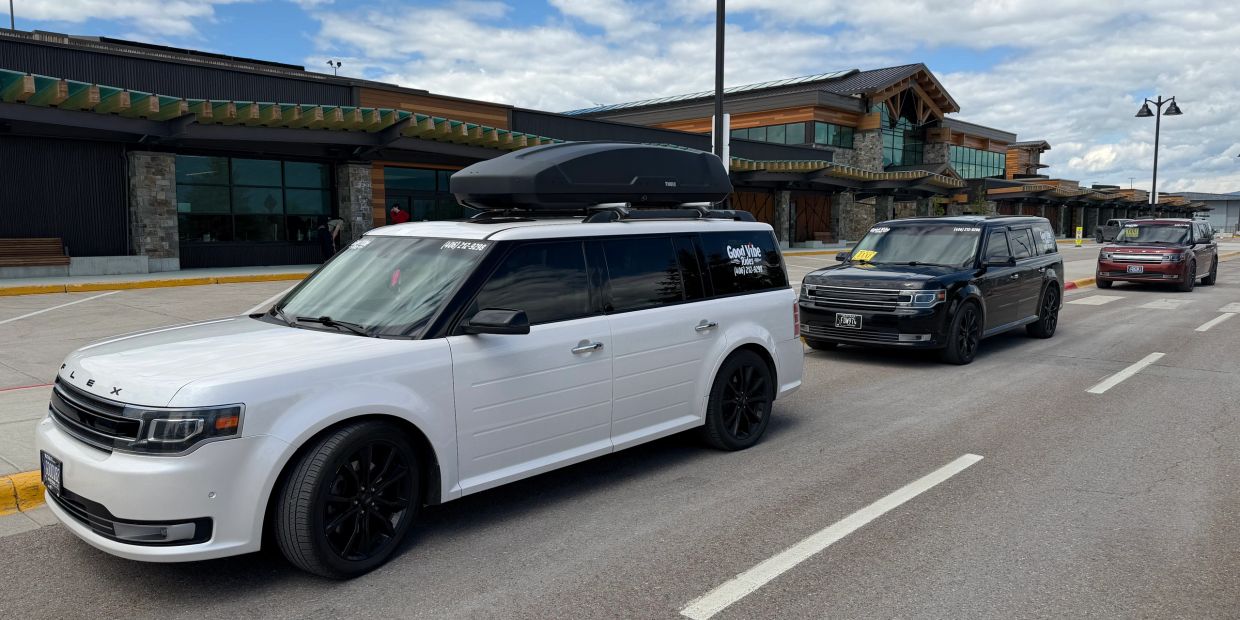 Good Vibe Rides Ford Flex SUV’s lined up to pick up passengers at Glacier Park International Airport
