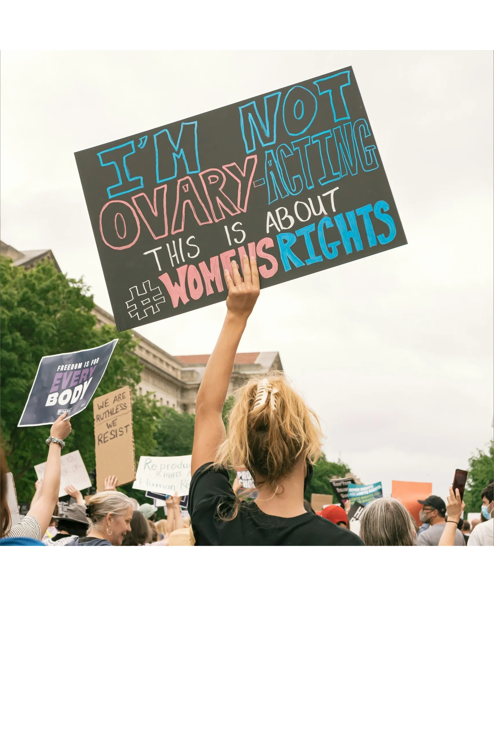 poster that says "I'm not ovary-acting. This is about women's rights".