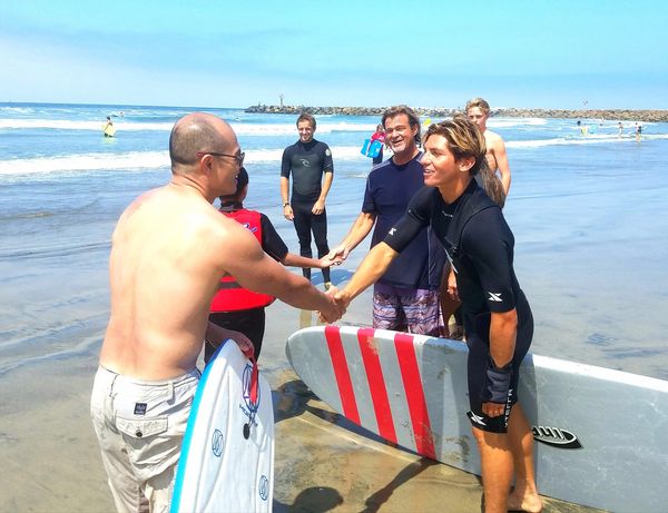 Yehuda and volunteers shaking hands and meeting with family before a session.