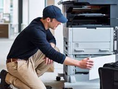 Man fixing a printer.