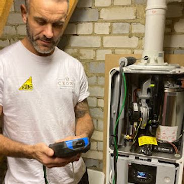 A professional checking a boiler