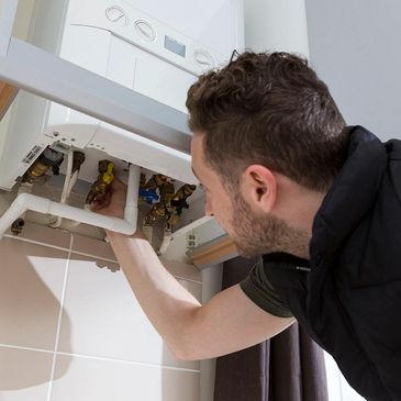 A professional checking the safety of a boiler