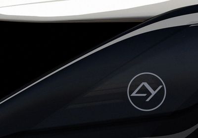 Close-up of a sleek black surface with a futuristic silver logo.
