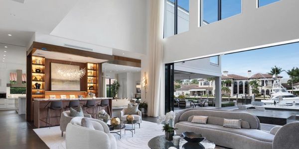 Modern living room with waterfront view and bar area.