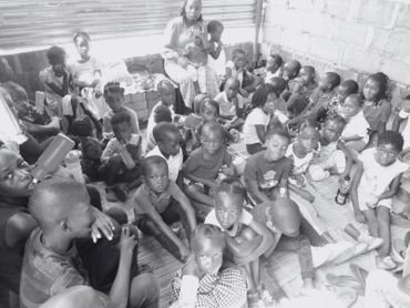 A large group of children sitting closely together indoors.