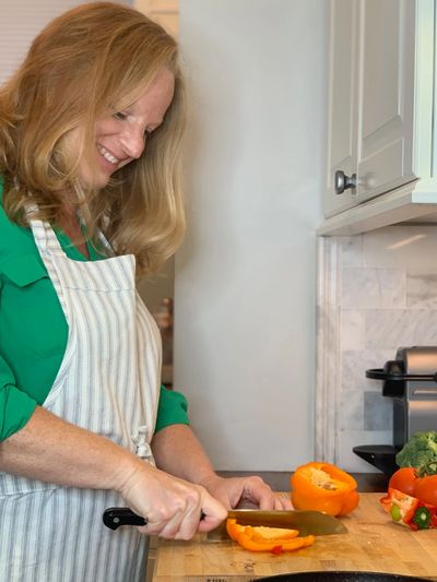 Erika Cook RD registered dietitian chopping vegetables for meal planning  