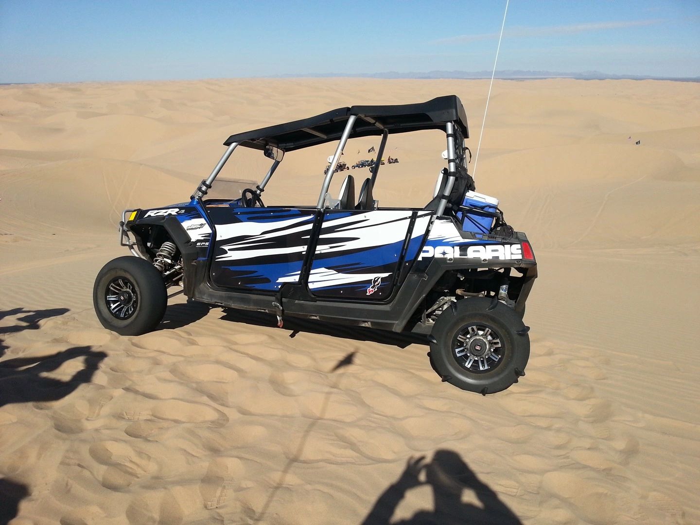 Side-by-side parked on sand dunes.