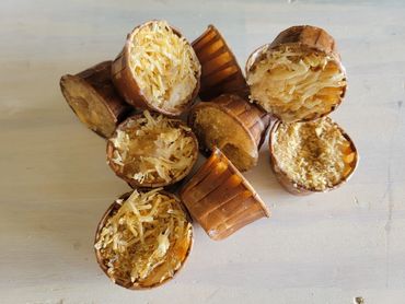 Loose Firestarter pile showing wax-filled cups and wood shavings.