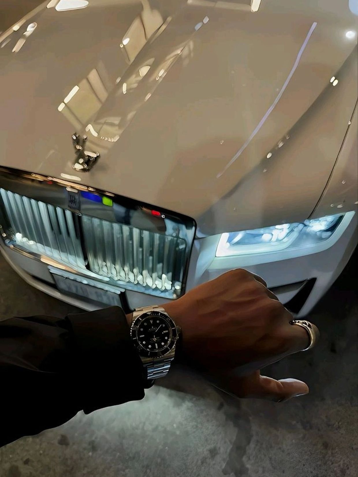 Luxury watch and car with illuminated headlights.