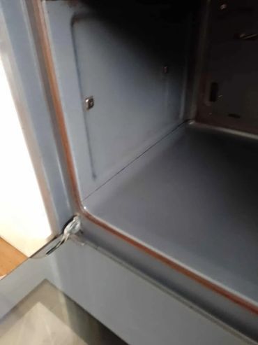 Empty open oven with a visible door seal.