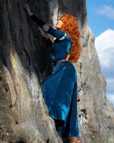 Merida climbing a cliff
