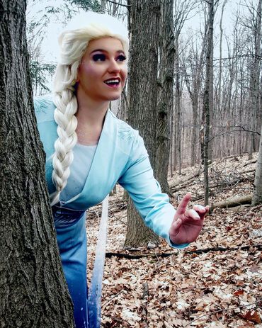 Elsa looking around in a forest