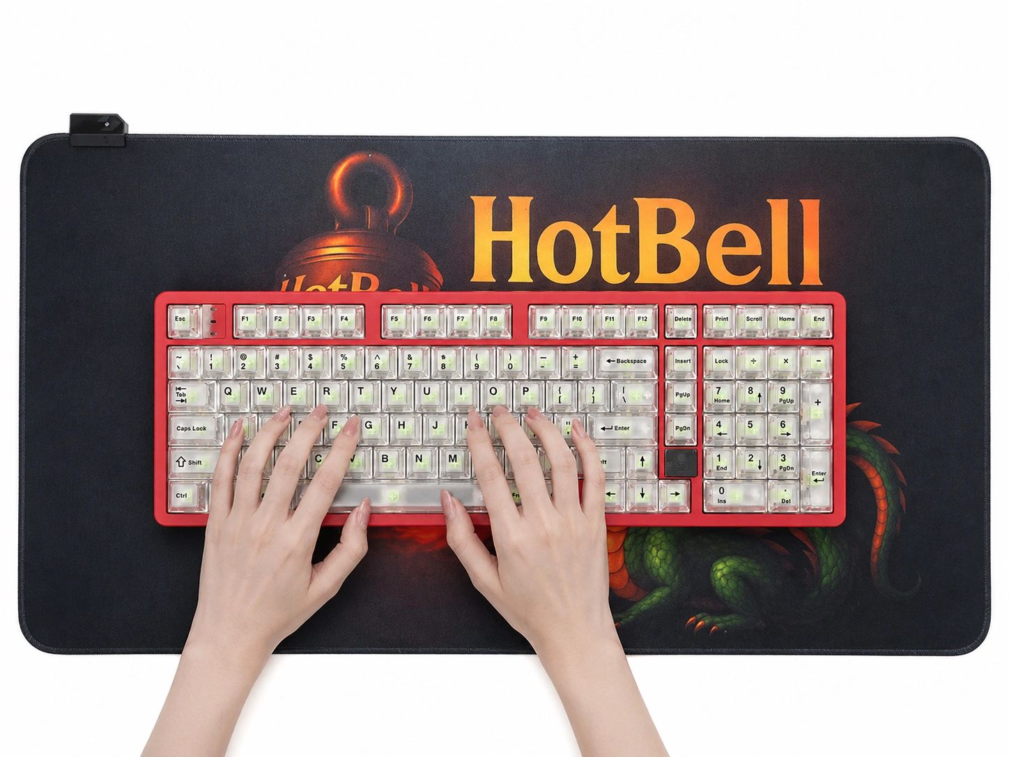 Hands typing on a red mechanical keyboard with transparent keycaps on a HotBell mouse pad.