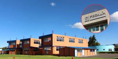 Modern orange and blue building with clear sky and Fiscalía sign.