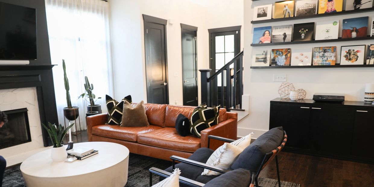 Living room with records and furniture and a fireplace.