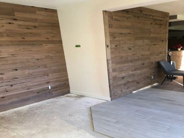 Wood style paneled wall and laminate flooring installation in