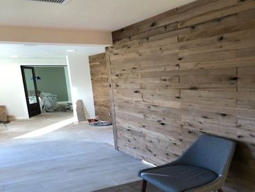 Wood style paneled wall and laminate flooring installation in