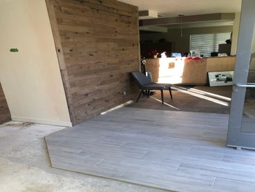 Wood style paneled wall and laminate flooring installation in