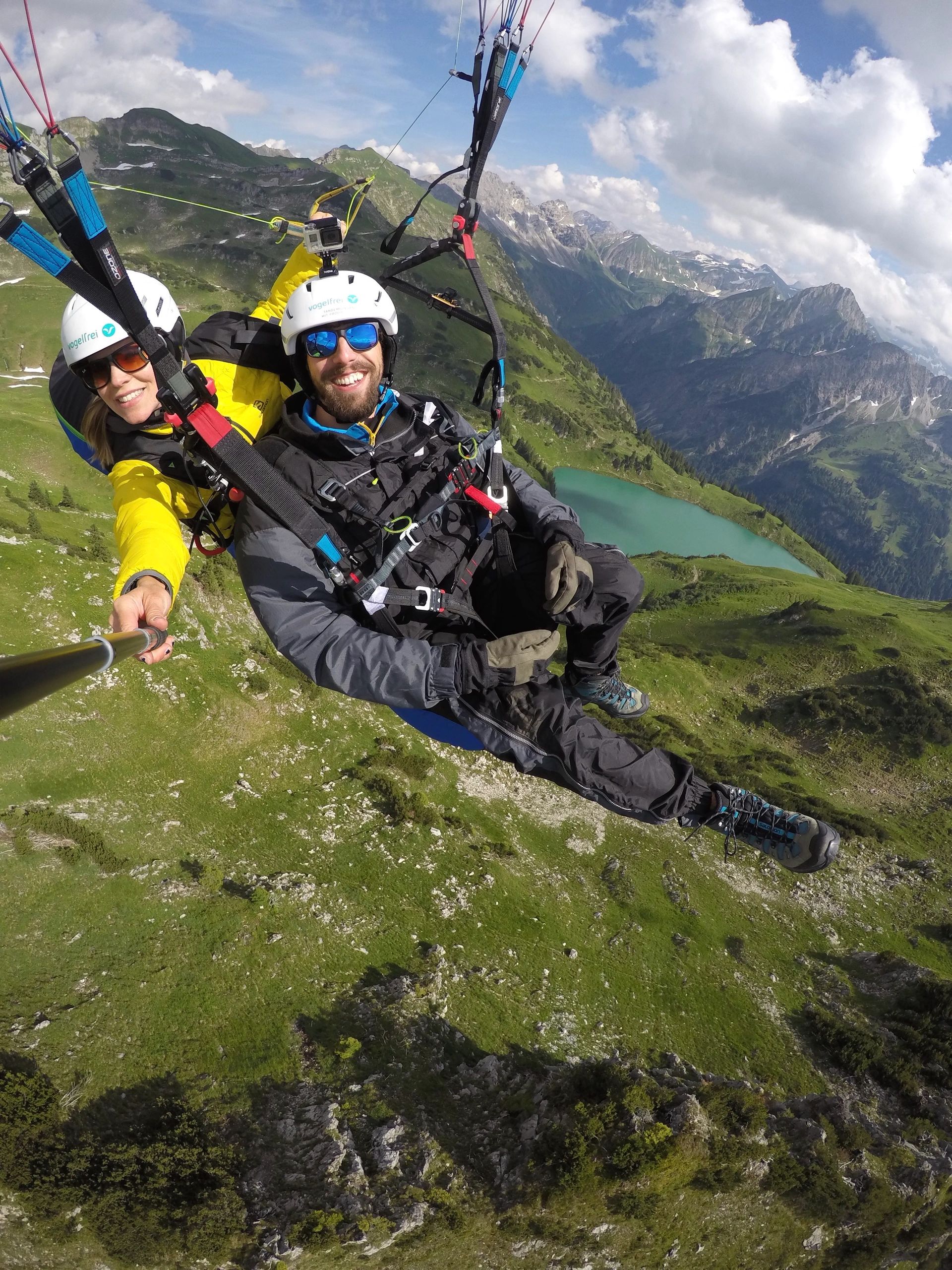 Tandem paragliding above the Nebelhorn in the German Alps. The Austrian Alps are in the background. 