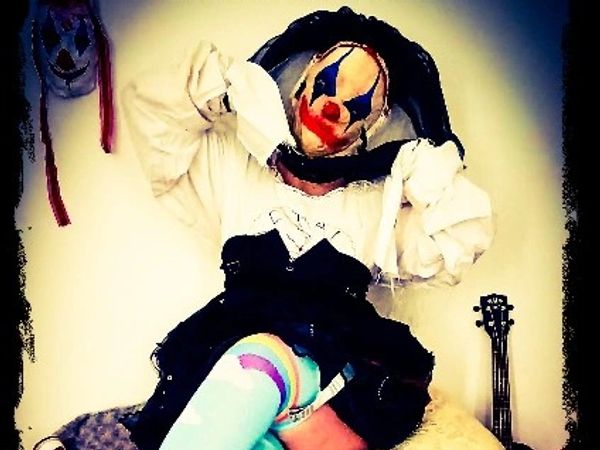 sitting. Clown mask.