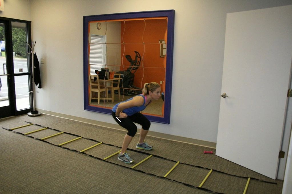 A woman practicing squats in the gym