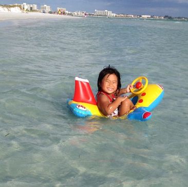 Chloe enjoying Siesta Beach on her floatie