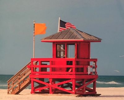 Red lifeguard stand at Siesta Beach during a windy day