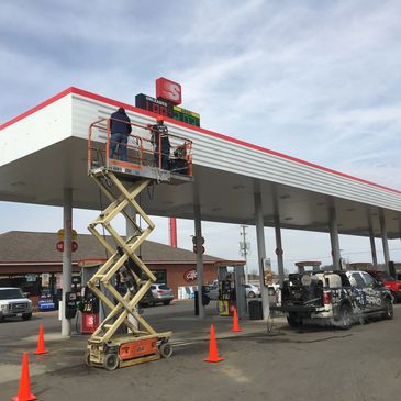 Wrapping a gas station canopy.
