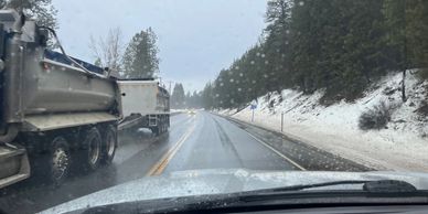 Snowy mountain road in North Idaho with truck traffic.