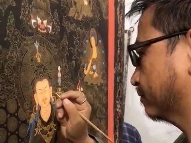 A senior artist making the face of Guru Rinporche- Padmasambhava Thangka.