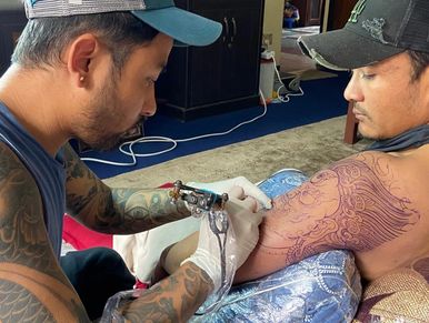 Proprietor and artist tattooing Vairab- the god of protection.